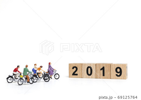 Miniature people : Friend Group ride bicycle with wooden number 2019 , Happy New Year concept. Miniature people : Friend Group ride bicycle with wooden number 2019 , Happy New Year concept. 69125764