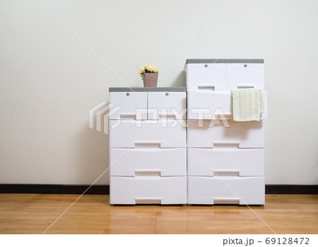 Stacks of white plastic cabinets with drawers Stacks of white plastic cabinets with drawers 69128472