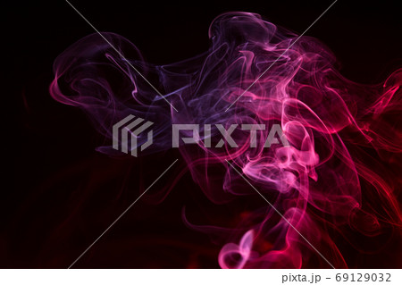 Colorful smoke close-up on a black background Colorful smoke close-up on a black background 69129032
