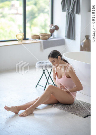 Young woman suffering from pain in her stomach 69129166