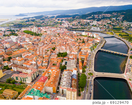 Pontevedra cityscape with a modern apartment buildings and sea bay Pontevedra cityscape with a modern apartment buildings and sea bay 69129470