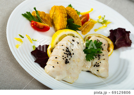 Hake steamed with corn, greens and lemon. Recipe 69129806