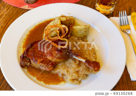 Confit duck leg with sauerkraut and dumplings 69130268