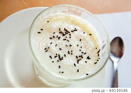 Sweet white homemade pudding served at plate with spoon 69130586