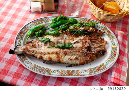 Grilled sea bass with peppers Grilled sea bass with peppers 69130829