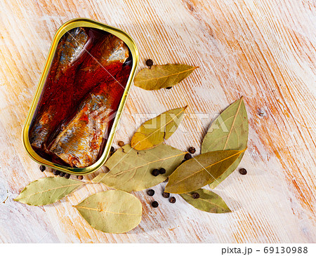 Canned sea fish, mackerel fillets in tomato served with peppers and bay leaf Canned sea fish, mackerel fillets in tomato served with peppers and bay leaf 69130988