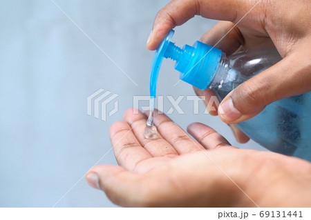 close up of young man hand using sanitizer gel for preventing virus  69131441