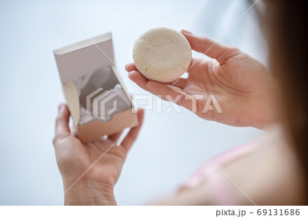 Woman trying a new scrabing soap product 69131686
