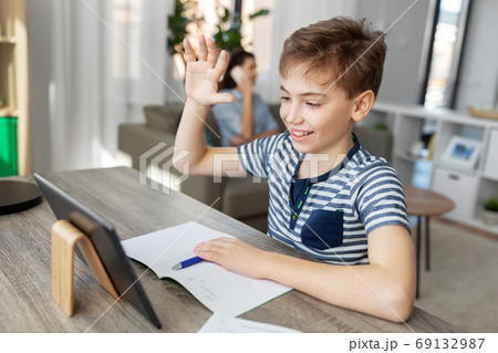 boy having video calll on tablet pc at home boy having video calll on tablet pc at home 69132987