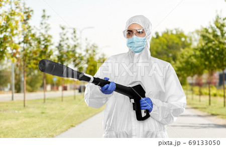 sanitation worker in hazmat with pressure washer 69133050