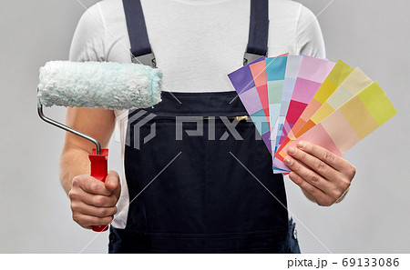 close up of painter with roller and color charts 69133086