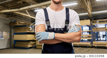 close up of male builder in overall and gloves close up of male builder in overall and gloves 69133098