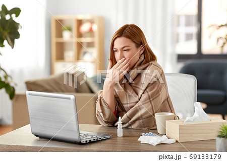 sick woman having video call on laptop at home 69133179