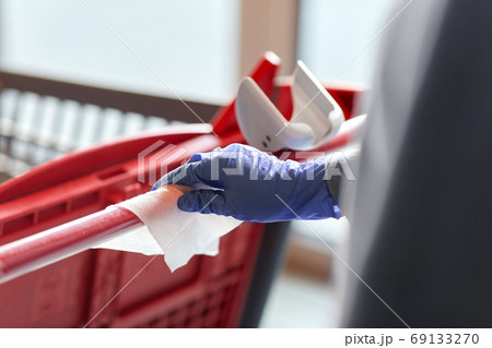 hand cleaning shopping cart handle with wet wipe 69133270