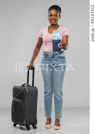 happy young woman with air ticket and travel bag happy young woman with air ticket and travel bag 69133415