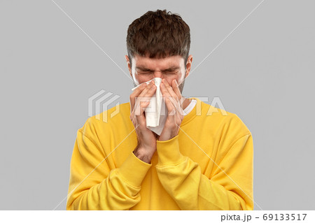 man with paper napkin blowing nose man with paper napkin blowing nose 69133517