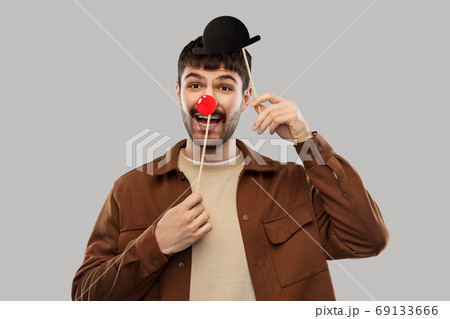 smiling man with bowler hat and red clown nose 69133666