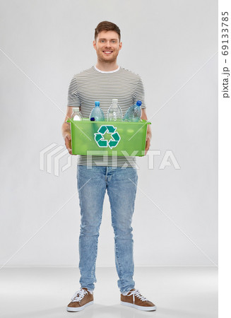 smiling young man sorting plastic waste 69133785