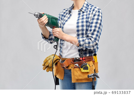 woman or builder with drill and work tools woman or builder with drill and work tools 69133837