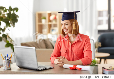 student woman with laptop and diploma at home 69134081