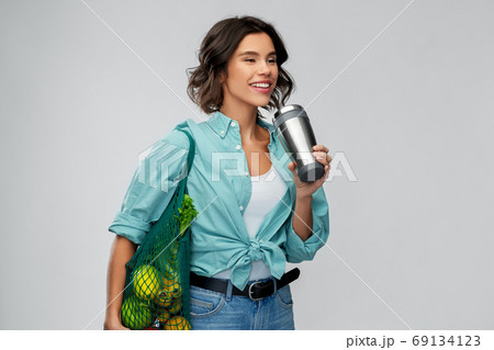 happy smiling woman with food in reusable net bag happy smiling woman with food in reusable net bag 69134123