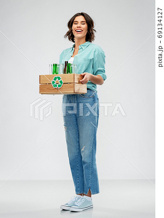 smiling young woman sorting glass waste smiling young woman sorting glass waste 69134127