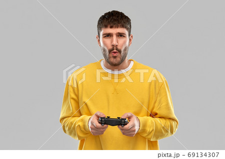 man or gamer with gamepad playing video game man or gamer with gamepad playing video game 69134307