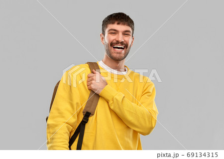 happy smiling young man with backpack happy smiling young man with backpack 69134315