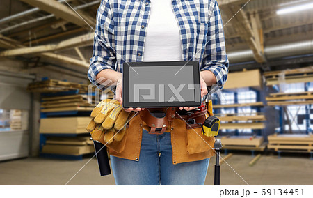female worker with tools and tablet pc at factory female worker with tools and tablet pc at factory 69134451