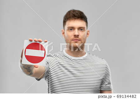 young man showing stop sign young man showing stop sign 69134482