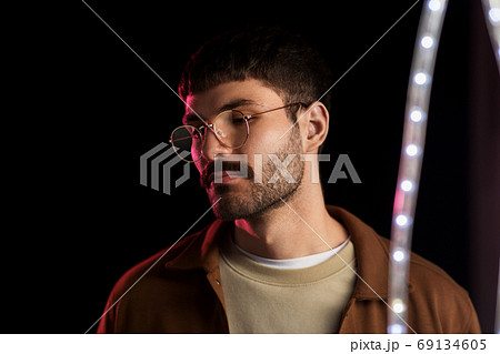 man in glasses over neon lights at nightclub man in glasses over neon lights at nightclub 69134605