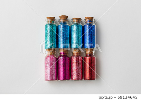 set of glitters in bottles over white background set of glitters in bottles over white background 69134645
