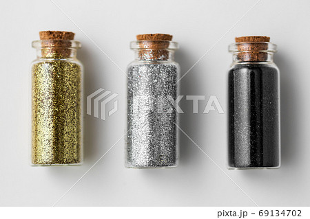 set of glitters in bottles over white background 69134702