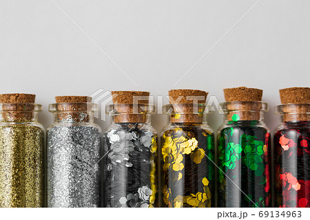 set of glitters in bottles over white background 69134963