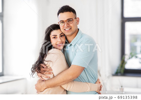 happy couple hugging at home happy couple hugging at home 69135398