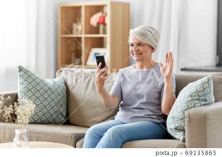 senior woman having video call on smartphone senior woman having video call on smartphone 69135865