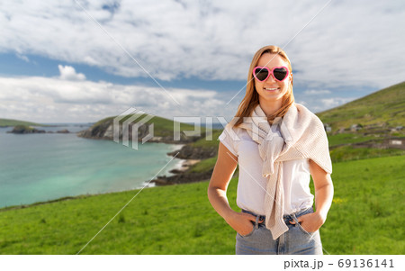woman wearing heart-shaped sunglasses in ireland 69136141