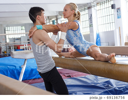 Man coaching woman in gym Man coaching woman in gym 69136756