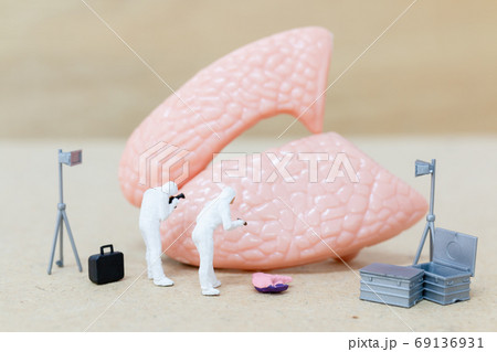 Miniature people , Scientist observing and discussing about huma 69136931