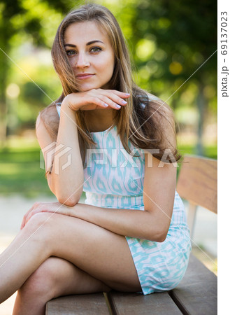 portrait of positive young female portrait in garden 69137023