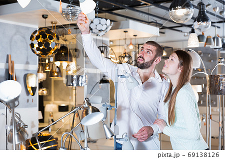 Portrait of family couple choosing floor lamp and other Portrait of family couple choosing floor lamp and other 69138126