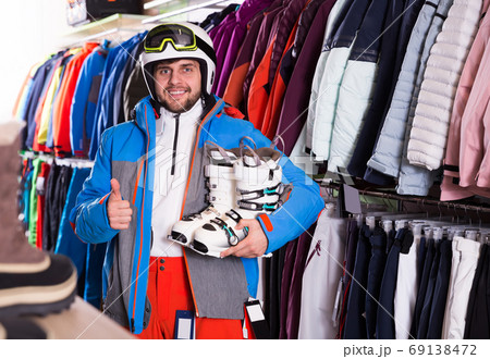 man standing with purchased ski outfit 69138472