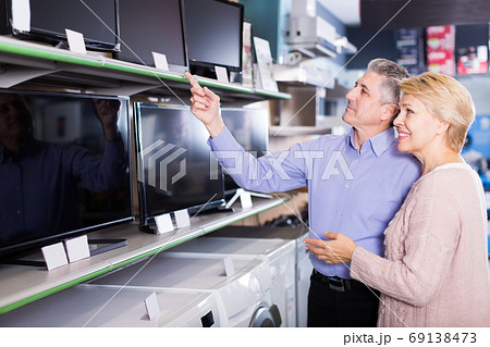 Lovely mature married couple are choosing home modern TV Lovely mature married couple are choosing home modern TV 69138473