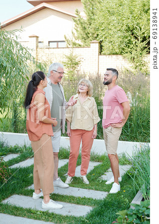 Four People Talking About Something 69138941