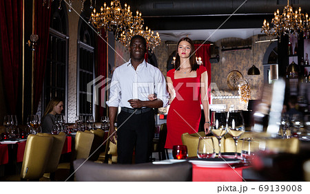Man and woman walking in luxury restaurant Man and woman walking in luxury restaurant 69139008