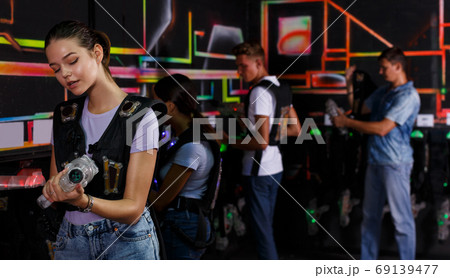 people looking laser guns and clothes together 69139477