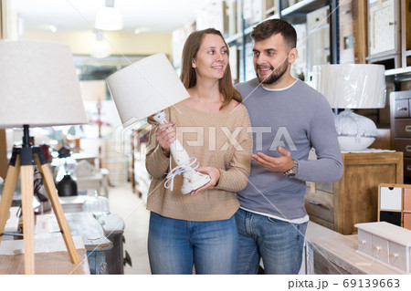 Couple choosing table lamp Couple choosing table lamp 69139663