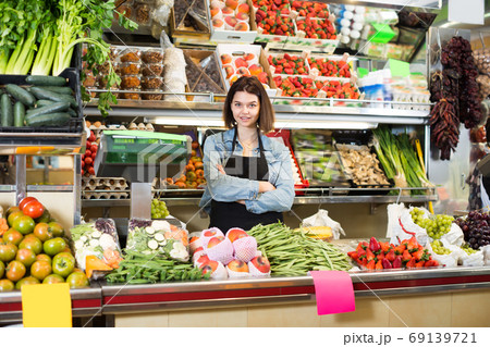 Adult woman seller displaying assortment Adult woman seller displaying assortment 69139721
