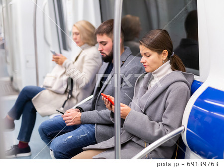 Girl with phone in metro car 69139763