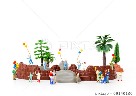 Miniature people:  Happy family holding balloon in The park , World Children's Day concept 69140130